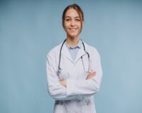 woman-doctor-wearing-lab-coat-with-stethoscope-isolated